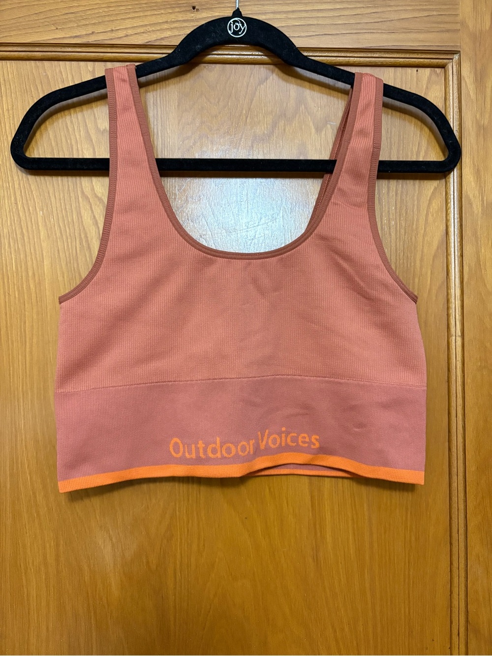 Outdoor Voices coral sports bra with bright orange trim